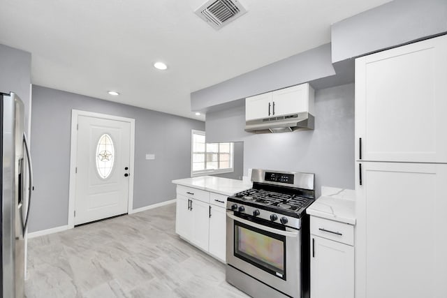 kitchen with visible vents, under cabinet range hood, light stone counters, stainless steel appliances, and white cabinets