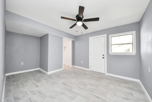 interior space with a closet, a ceiling fan, and baseboards