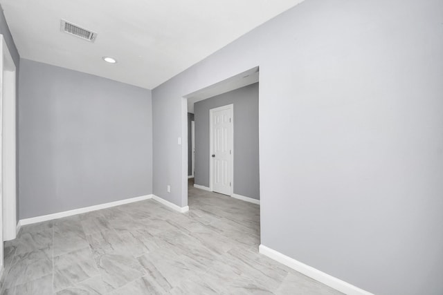 unfurnished room with visible vents and baseboards