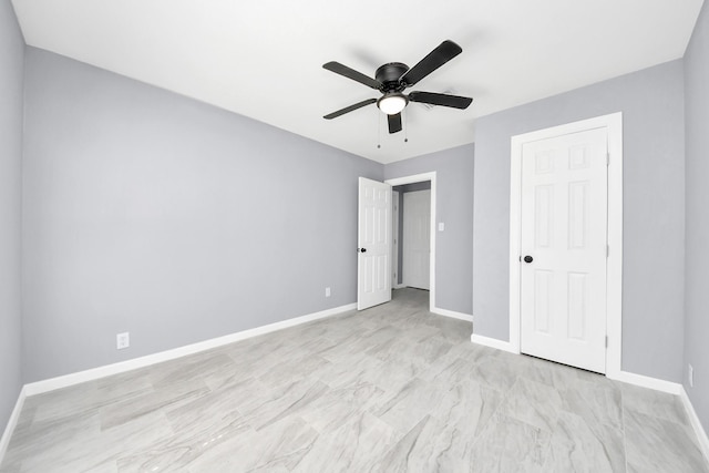 unfurnished bedroom with ceiling fan and baseboards