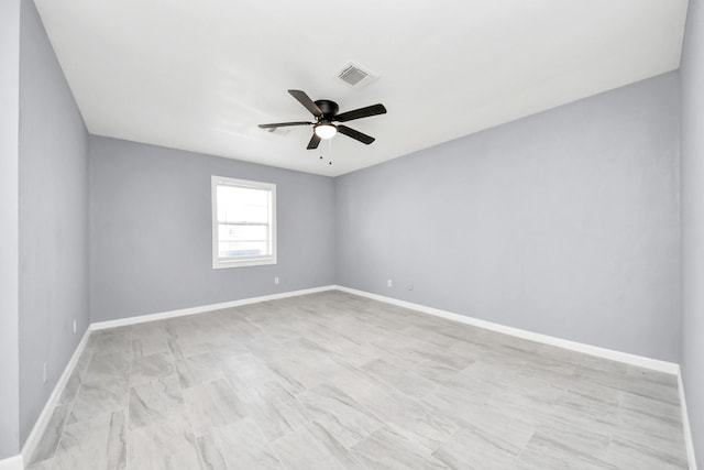 unfurnished room featuring visible vents, baseboards, and a ceiling fan