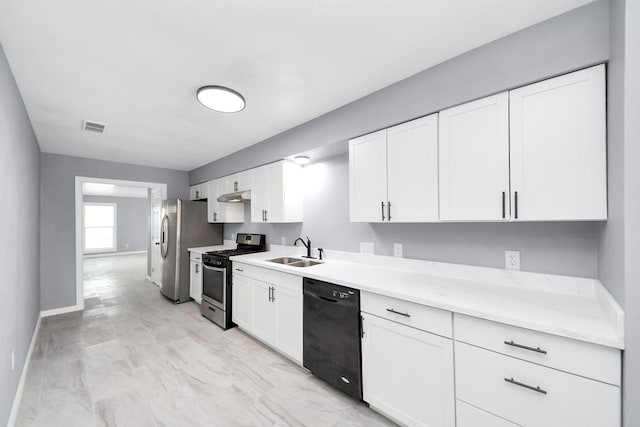 kitchen featuring visible vents, white cabinetry, stainless steel appliances, and a sink