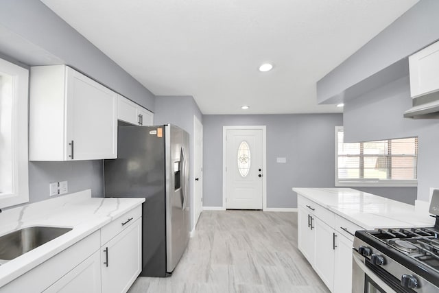 kitchen featuring a sink, light stone counters, white cabinetry, recessed lighting, and stainless steel appliances