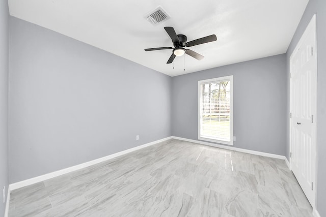 spare room featuring visible vents, baseboards, and ceiling fan