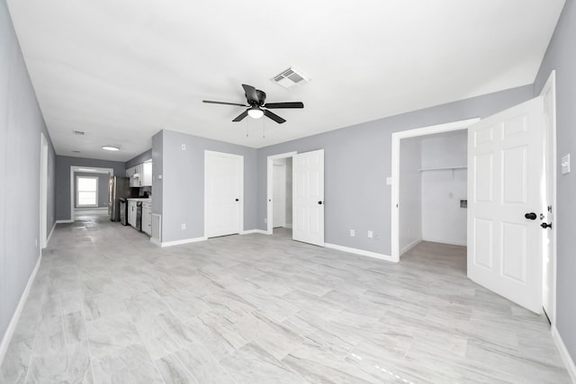 unfurnished living room featuring visible vents, baseboards, and a ceiling fan