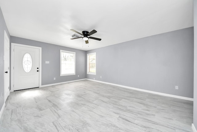 entryway with baseboards and ceiling fan