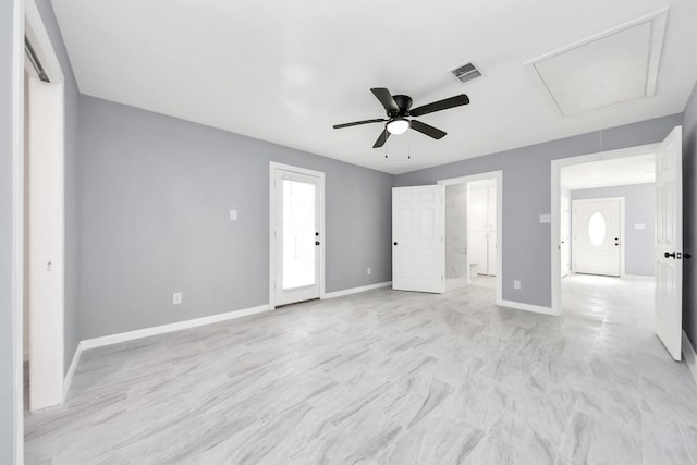 unfurnished bedroom featuring a ceiling fan, attic access, baseboards, and visible vents