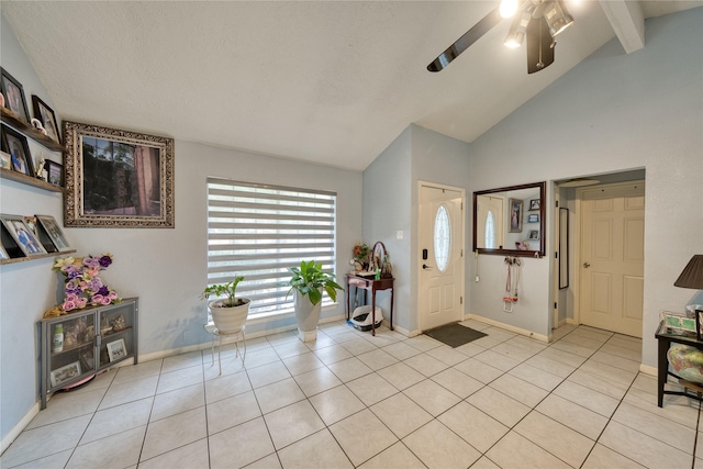 foyer with light tile patterned floors, beam ceiling, a ceiling fan, and baseboards