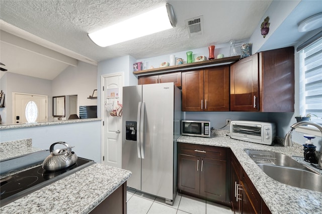 kitchen with visible vents, a toaster, appliances with stainless steel finishes, a textured ceiling, and a sink