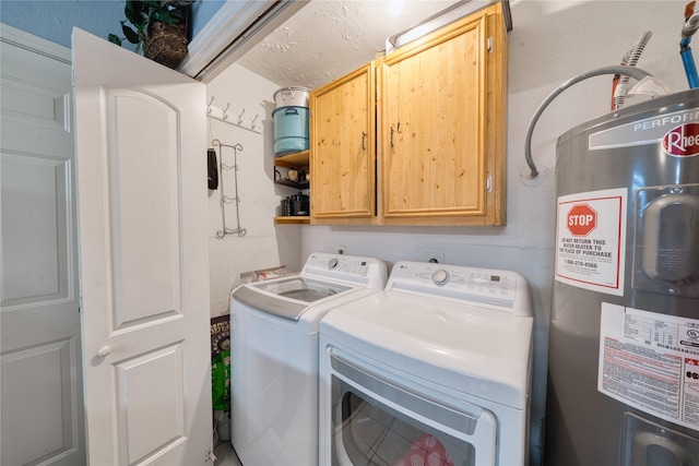 laundry area with cabinet space, electric water heater, and washer and clothes dryer