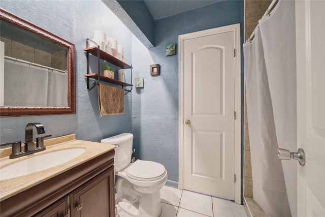 full bathroom featuring toilet, a shower with shower curtain, tile patterned flooring, vanity, and a textured wall