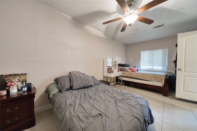 bedroom featuring tile patterned flooring, visible vents, baseboards, and ceiling fan