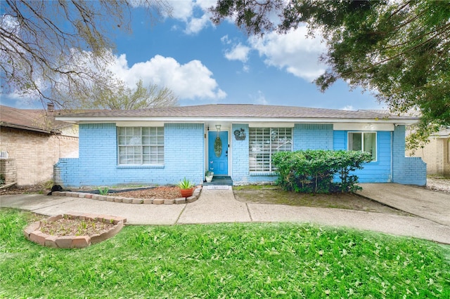 single story home with brick siding and a front lawn