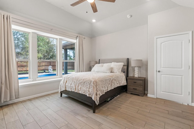 bedroom featuring vaulted ceiling, a ceiling fan, baseboards, and wood finish floors