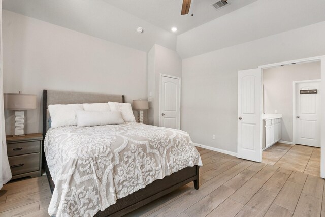 bedroom with wood finish floors, visible vents, baseboards, and vaulted ceiling