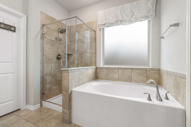 bathroom featuring tile patterned floors, a garden tub, and a shower stall