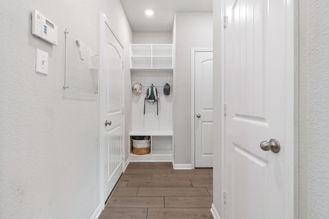 mudroom with baseboards and wood tiled floor