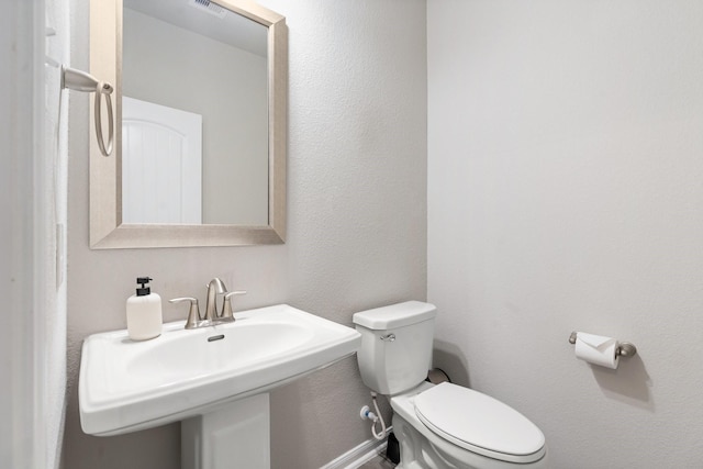 bathroom with visible vents, toilet, and a sink