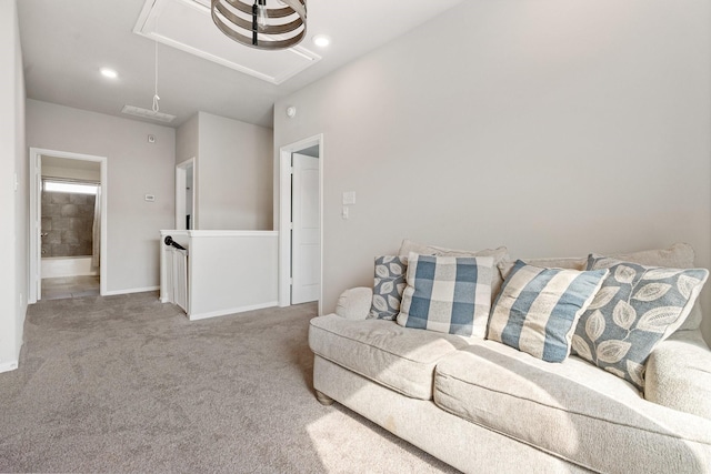 carpeted living room with recessed lighting, baseboards, and attic access