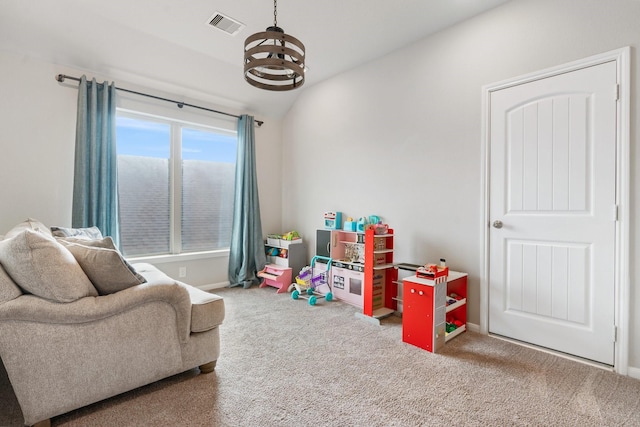 rec room featuring a chandelier, visible vents, carpet, and vaulted ceiling