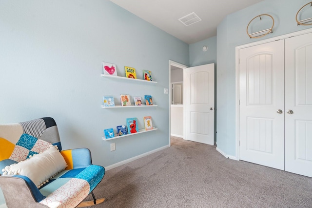 living area featuring baseboards, visible vents, and carpet floors