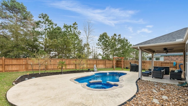 view of swimming pool with an outdoor living space, a pool with connected hot tub, a fenced backyard, a patio area, and a ceiling fan