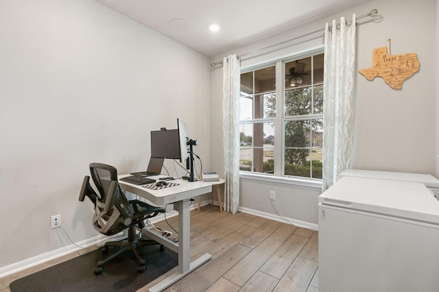 office area with light wood-style flooring and baseboards