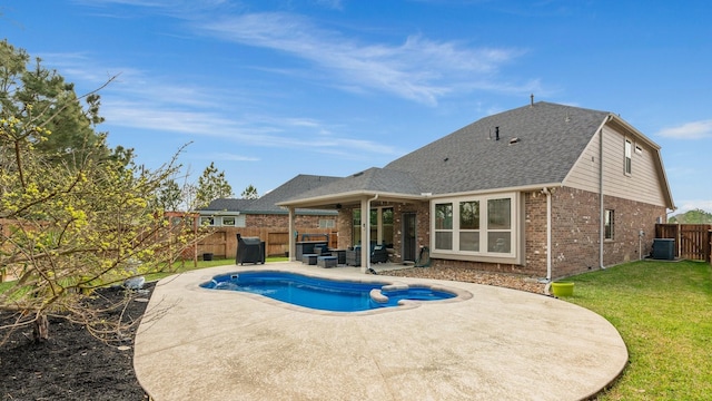 view of pool featuring central air condition unit, a pool with connected hot tub, a patio, a fenced backyard, and a yard