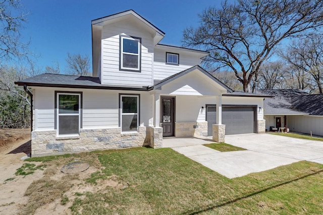 view of front of property with concrete driveway, a garage, stone siding, and a front lawn