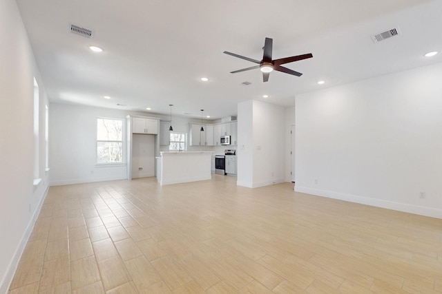 unfurnished living room with visible vents, baseboards, light wood-type flooring, recessed lighting, and a ceiling fan