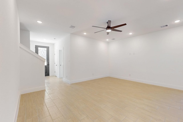 spare room featuring recessed lighting, light wood-type flooring, baseboards, and a ceiling fan