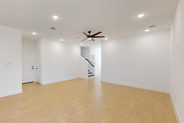 unfurnished room with stairs, recessed lighting, visible vents, and light wood finished floors