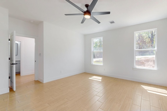 unfurnished room with visible vents, baseboards, a ceiling fan, and light wood finished floors