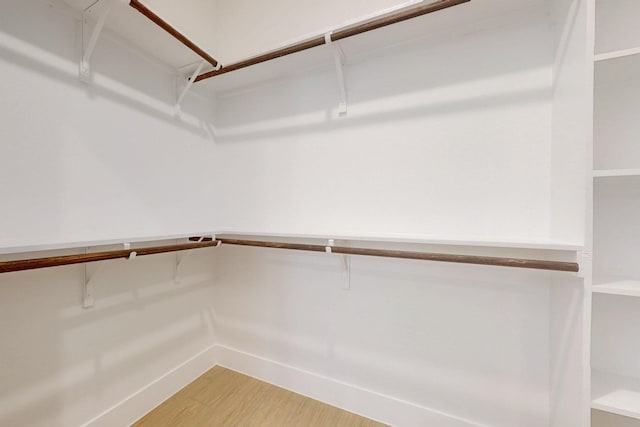 spacious closet with light wood-style floors