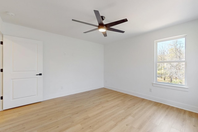 unfurnished room with a wealth of natural light, light wood-style flooring, and baseboards