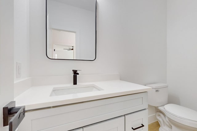 half bath featuring toilet and vanity