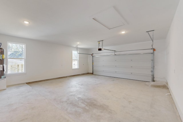 garage with recessed lighting, baseboards, and a garage door opener