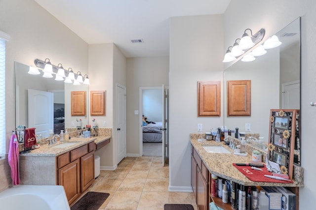 full bathroom featuring tile patterned floors, visible vents, connected bathroom, and a sink