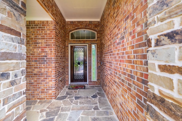 doorway to property with brick siding