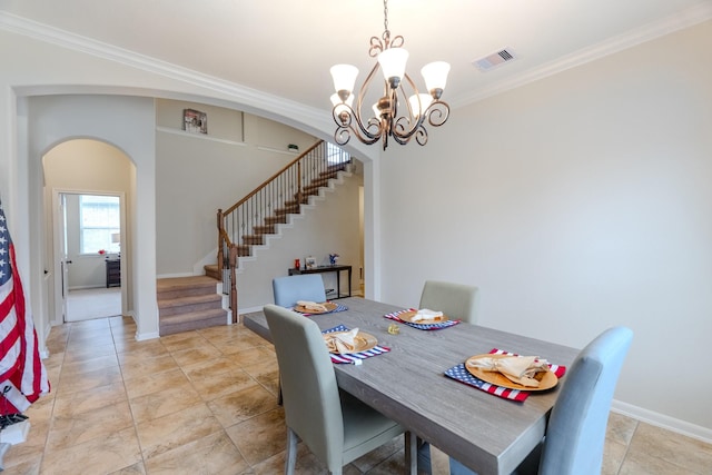 dining room featuring visible vents, arched walkways, ornamental molding, and stairs