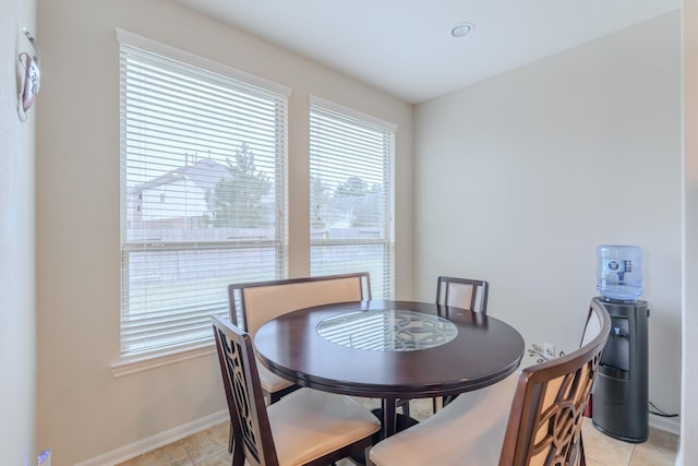 dining space with light tile patterned floors and baseboards