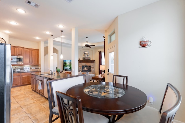 dining room with light tile patterned floors, visible vents, recessed lighting, a fireplace, and ceiling fan