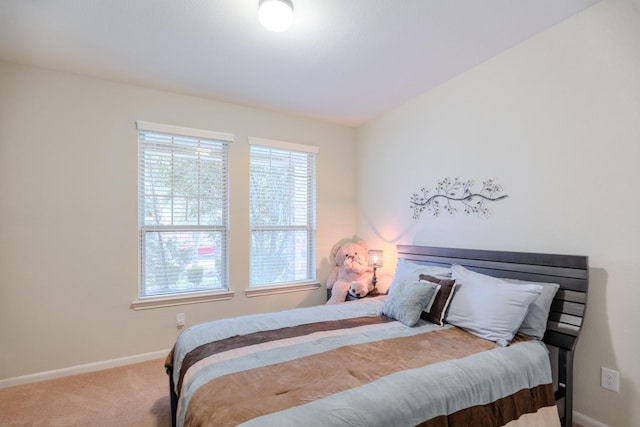 carpeted bedroom featuring baseboards