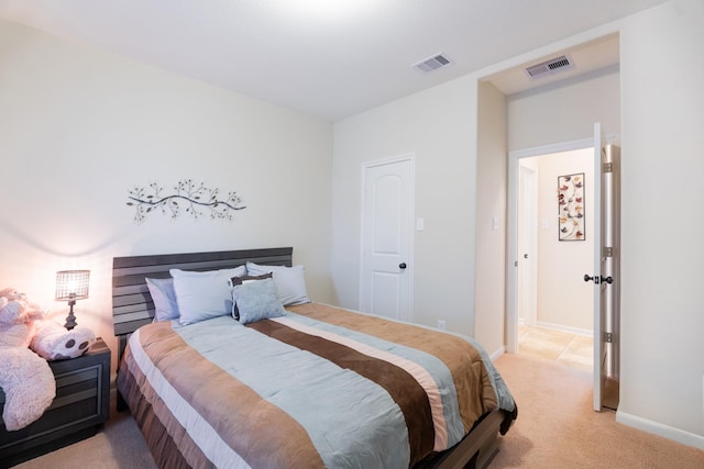 bedroom featuring visible vents, light colored carpet, and baseboards