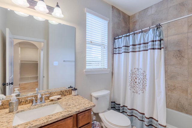 full bath with shower / tub combo, toilet, and vanity