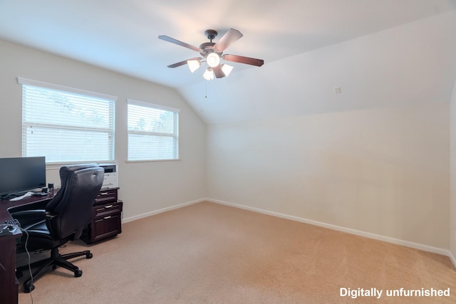 office space with baseboards, lofted ceiling, light colored carpet, and ceiling fan