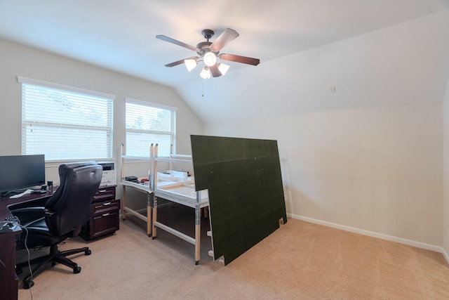 office space featuring light colored carpet, baseboards, ceiling fan, and vaulted ceiling