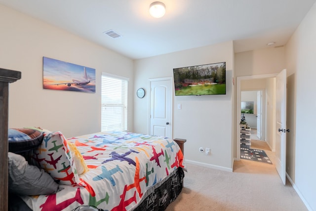 carpeted bedroom featuring visible vents and baseboards