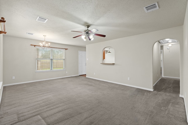 spare room with ceiling fan with notable chandelier, carpet, visible vents, and arched walkways