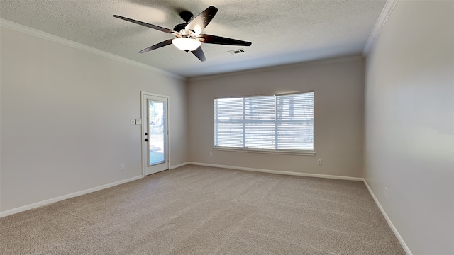 spare room featuring baseboards, visible vents, ornamental molding, a textured ceiling, and light carpet